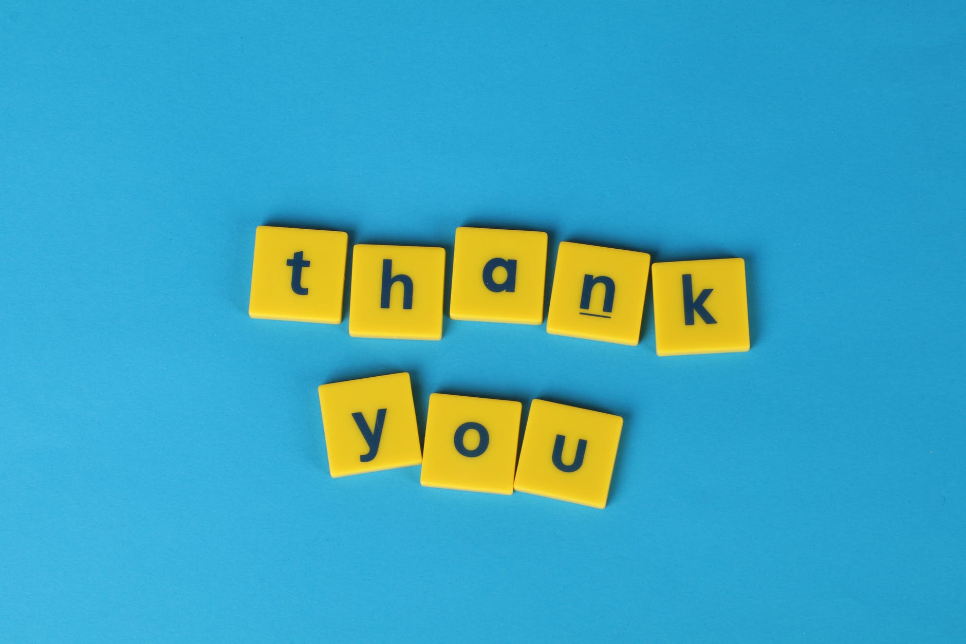 yellow letter tiles on blue background